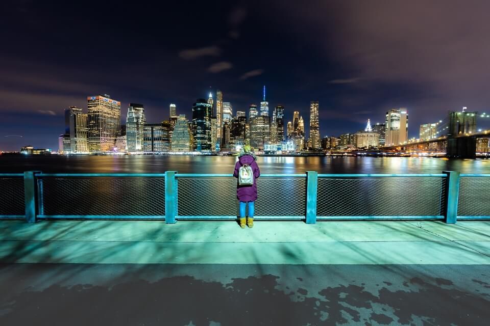 Woman posing for a photograph with the Lower Manhattan Skyline