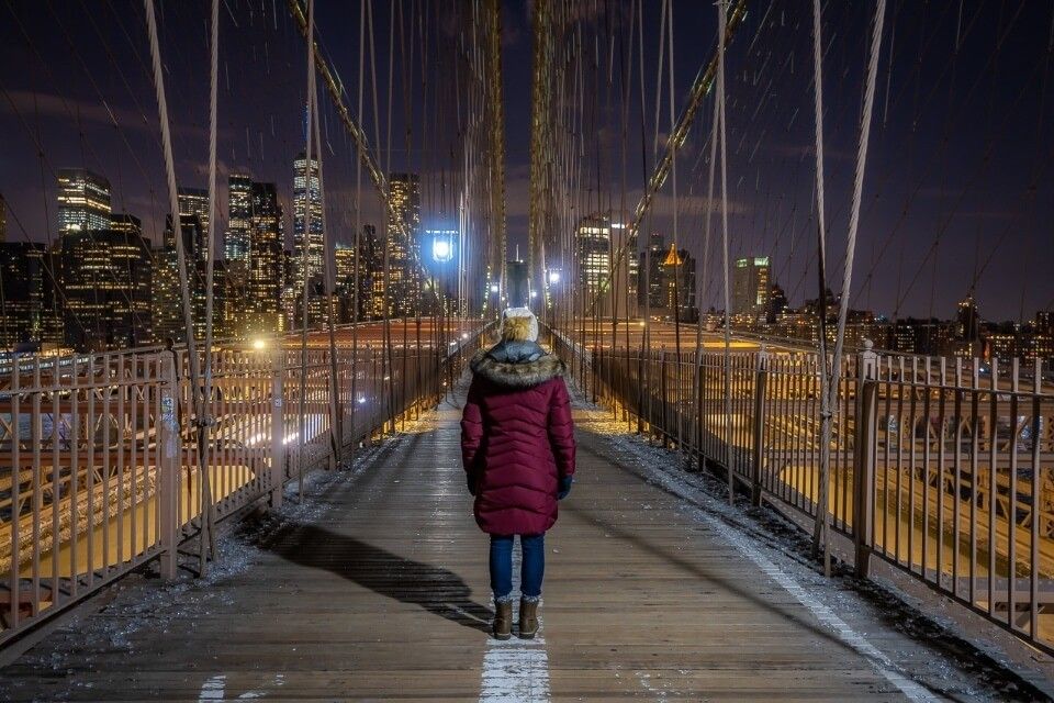 Woman standing in the middle of a predestrian walkway in New York City