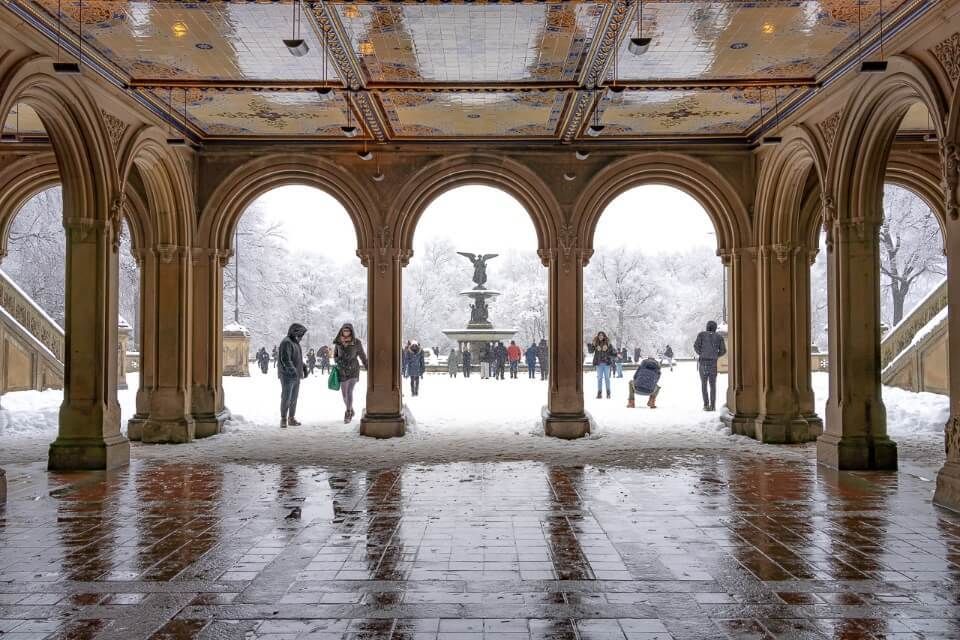 Bethesda Terrace busy with tourists and locals on a snow day in Winter