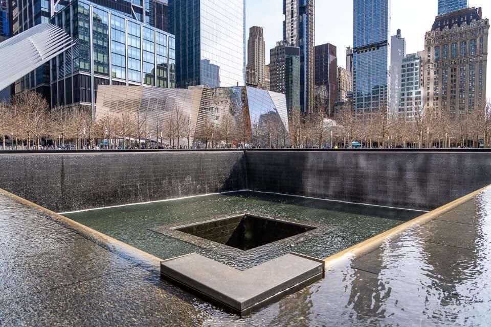 9/11 memorial and museum pools with buildings in late afternoon sun in lower manhattan new york city