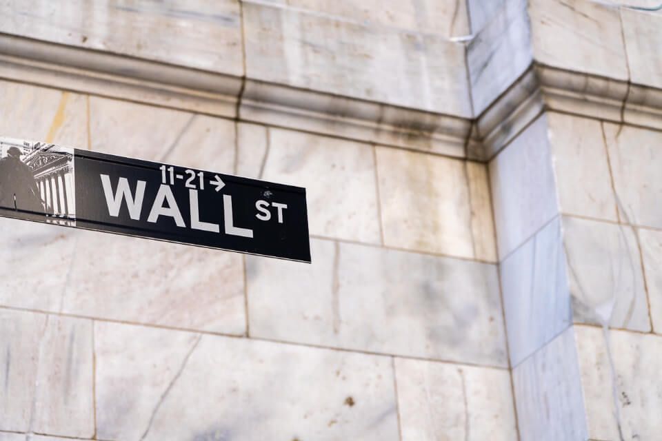 Wall Street Sign against wall backdrop