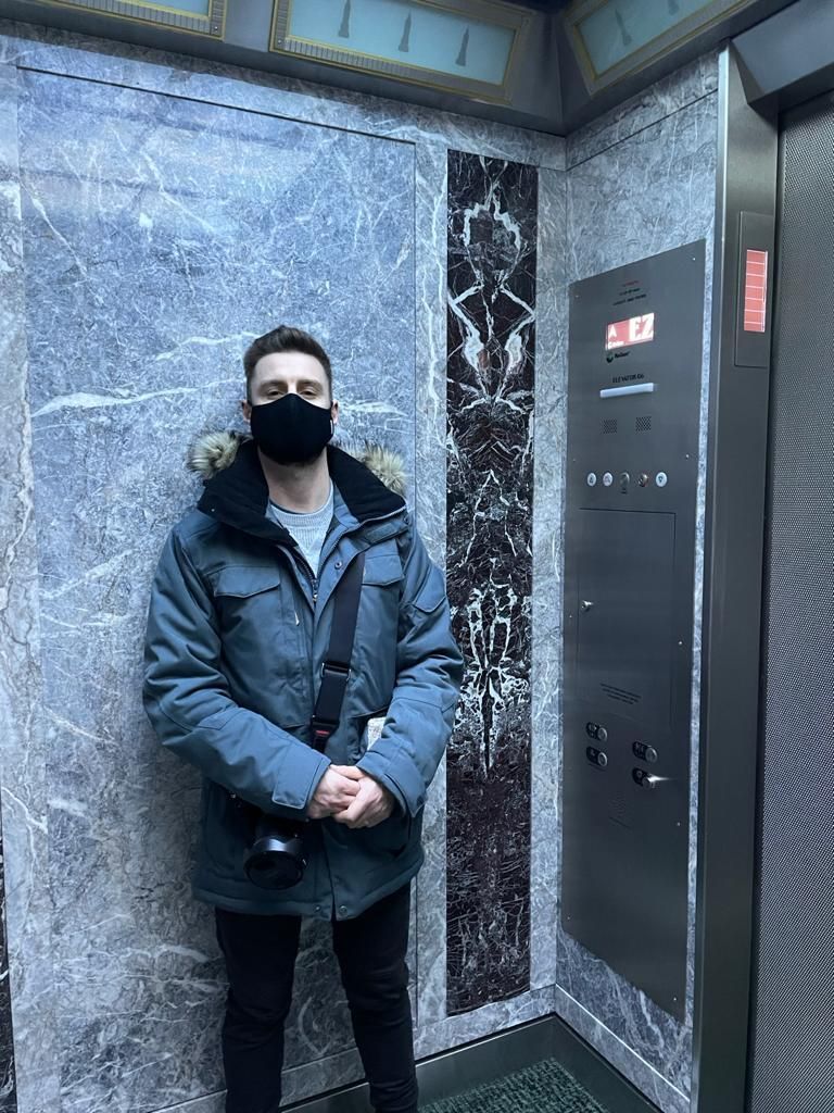 Man in elevator with mask on