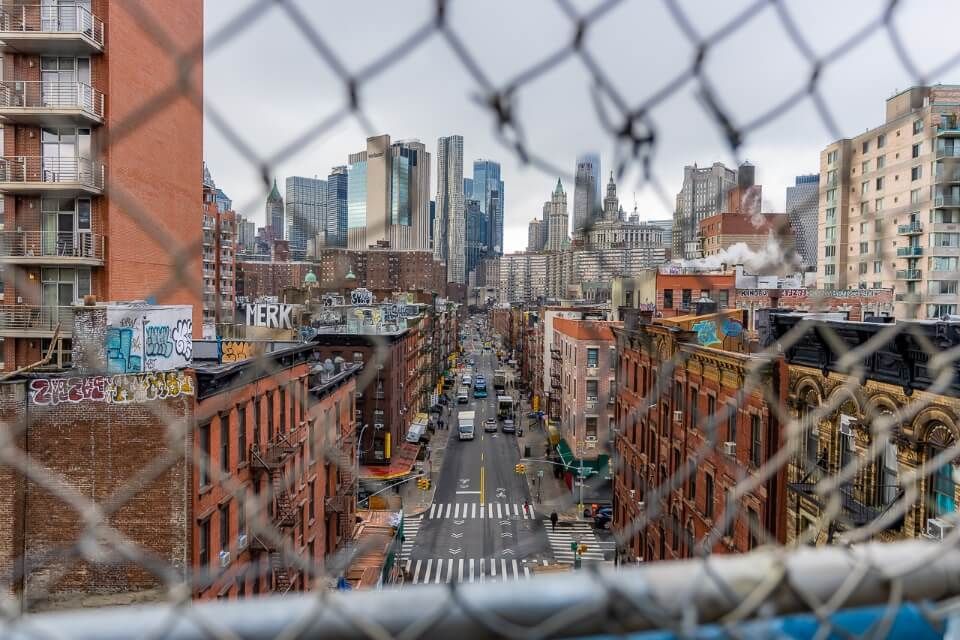 Hole in Fence famous photograph taken from Manhattan Bridge of Chinatown in NYC