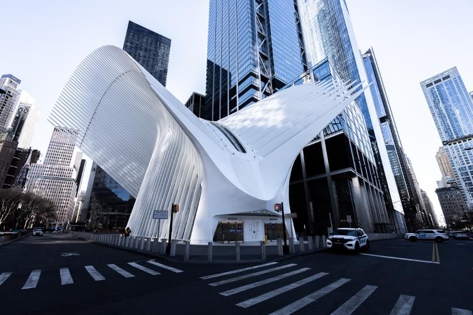 Oculus is a unique new york city photography location with dove like wings and surrounded by tall glass buildings