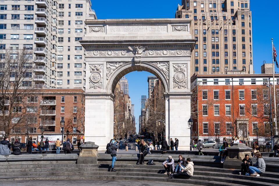 Washington Square Arch in midtown manhattan frames the road toward empire state building