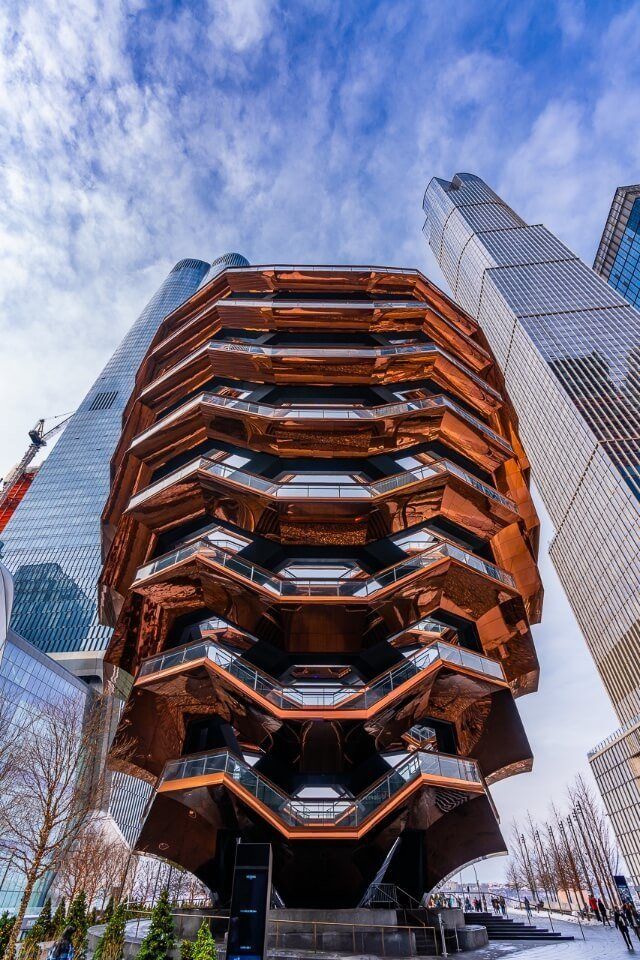 Vessel orange metal structure in Hudson yards from below one of the most unique and best things to see in new york city