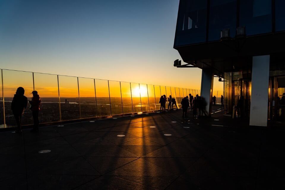 Sunset in new york city on top of hudson yards observation deck casting dark shadows