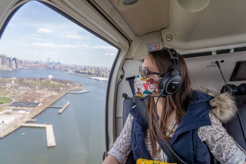 Woman sitting in a chopper looking at views of Midtown and Lower Manhattan