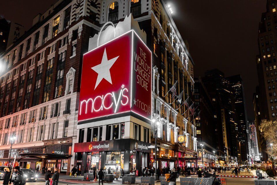 Macy's department store in new york city at night lit up red is a must visit for first time tourists