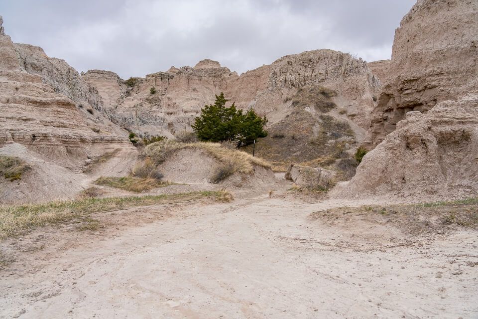 Rocks and dirt path with cloudy sky in south dakota