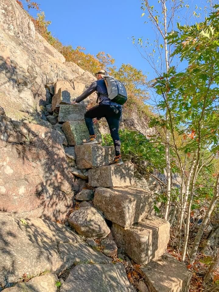 Man climbing steps on a cliffside