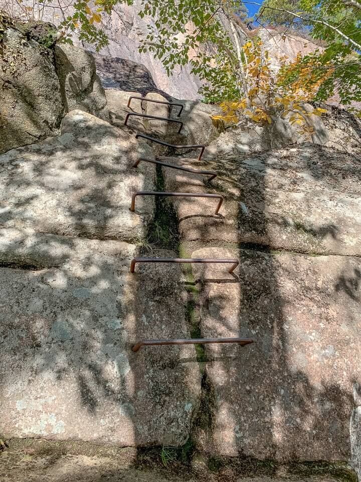 Iron rung ladder protruding out of granite rock in Maine