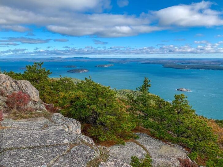 Incredibly beautiful view from the summit of Acadia National Park Precipice Trail hike rocks trees ocean and blue sky