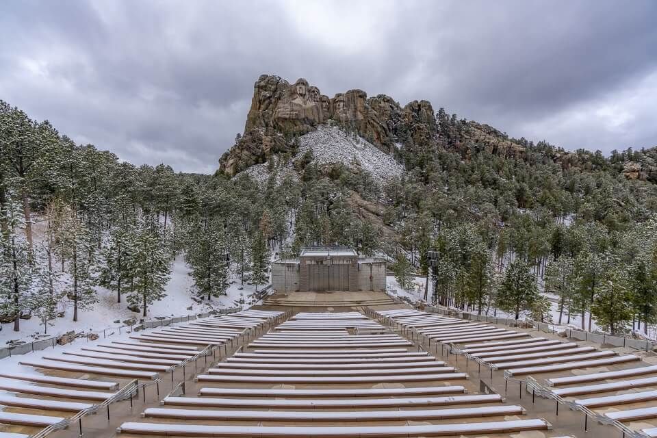 Mt Rushmore amphitheater seating empty on a cold snowy cloudy day
