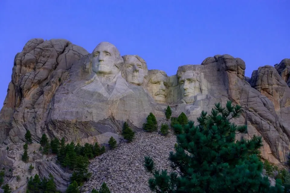 Mount Rushmore National Memorial before sunrise with purple sky