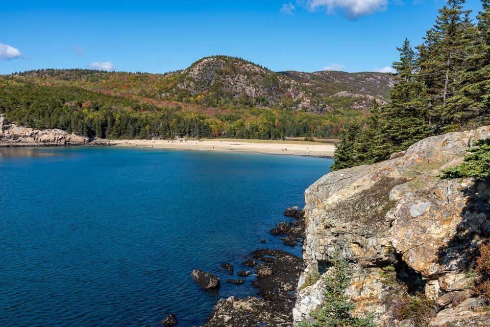 Great Head Trail hugs the coastline with view looking back over sand beach and out to sea