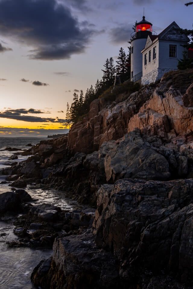 Photography at Bass Harbor Head Lighthouse is one of the most amazing things to do in acadia national park stunning white lighthouse on a cliff edge colorful sky