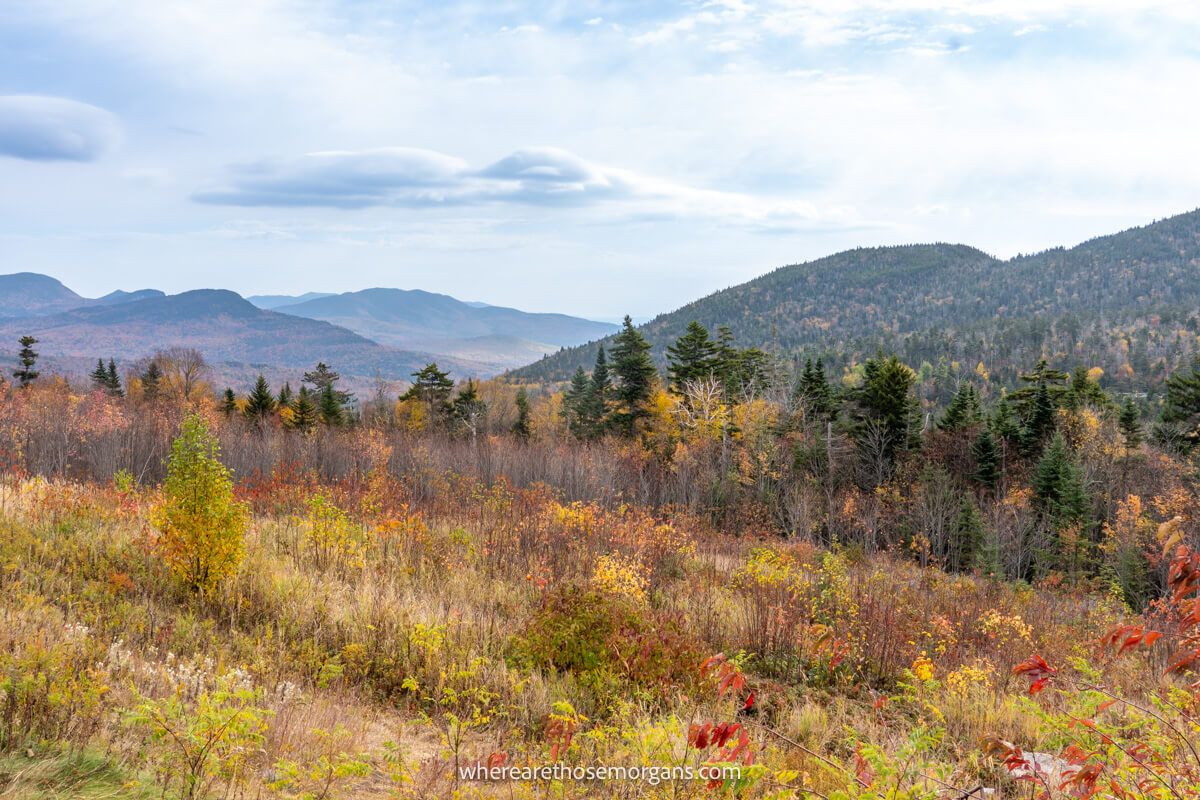 Far reaching views over rolling hills covered in fall foliage leaves from the Kancamagus Highway NH