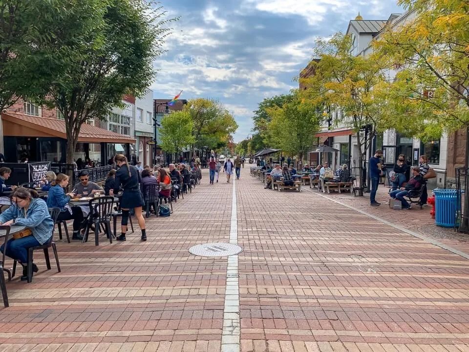 Hundreds of people eating and drinking on a pedestrian only street