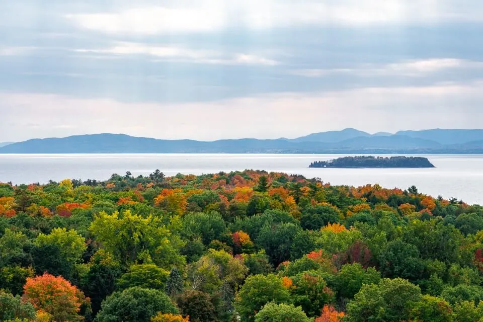 Stunning Lake Champlain with fall foliage colors in trees from an overlook in Burlington VT