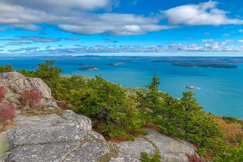 Acadia National Park is one of the best places to visit on a fall new england road trip precipice trail summit looking over ocean