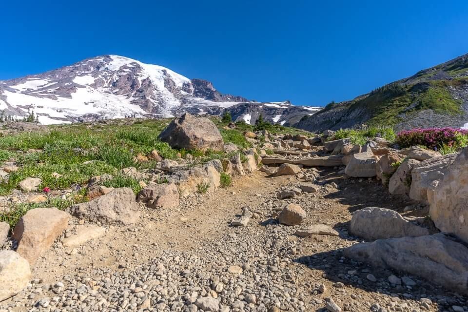 Close up of a footpath with volcano and blue sky