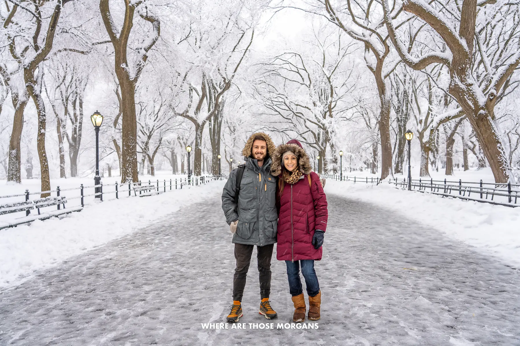 Photo of Mark and Kristen Morgan from Where Are Those Morgans standing together in heavy coats on The Mall in Central Park NYC in the depths of winter with snow on the ground and bare trees behind