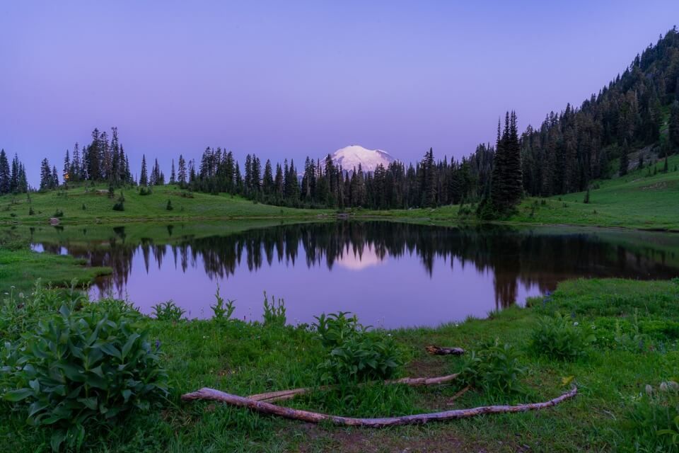 Tipsoo Lake Mt Rainier right before sunrise with a purple sky and reflection near naches peak loop trail hike