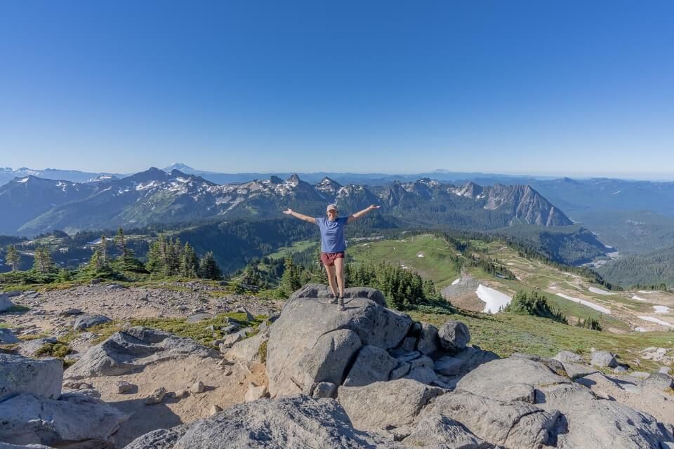 Kristen arms stretched at panorama point on skyline trail hike in mt rainier one of the best viewpoints in the park