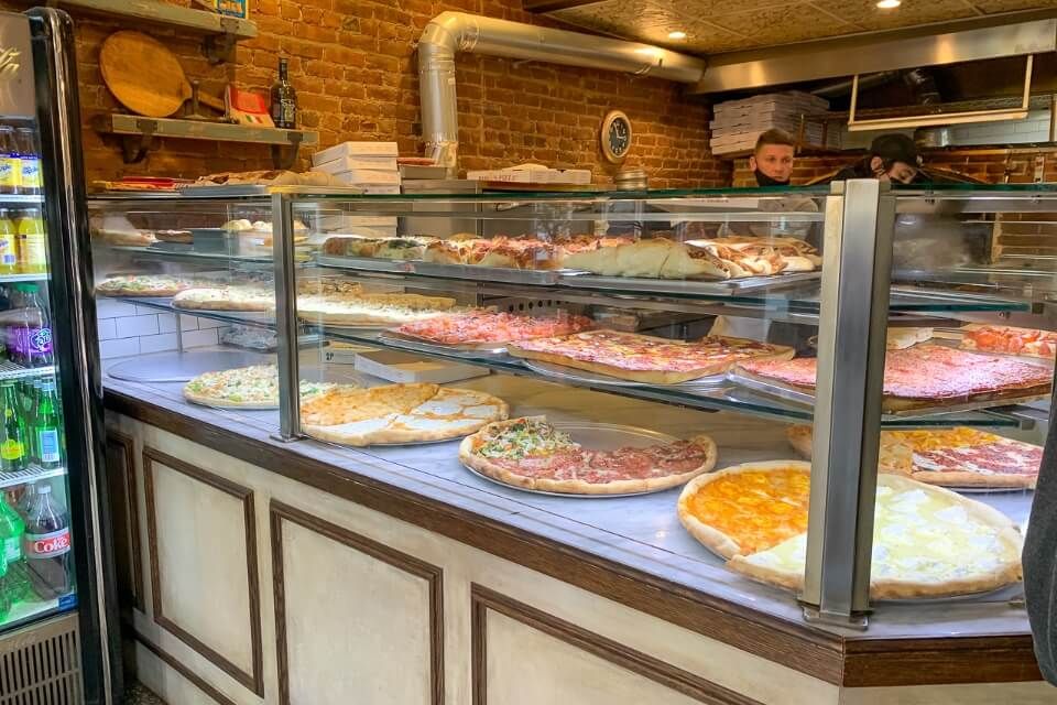 Several different kinds of pizza for sale 