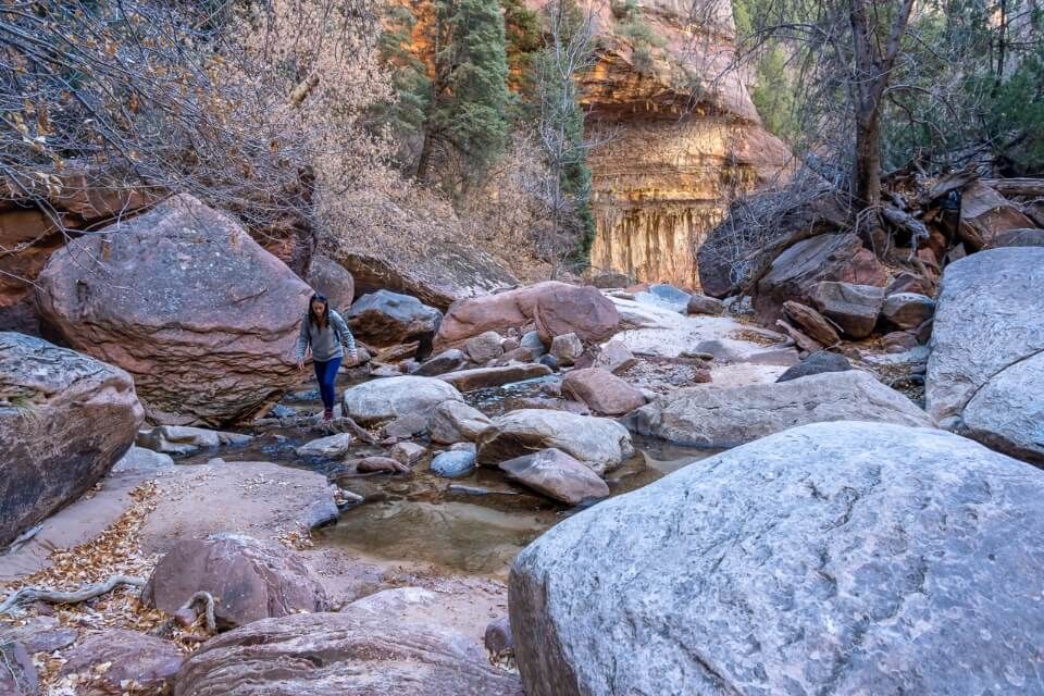 Hiking to The Subway in Zion National Park requires crossing river multiple times and navigating small rocks and boulders