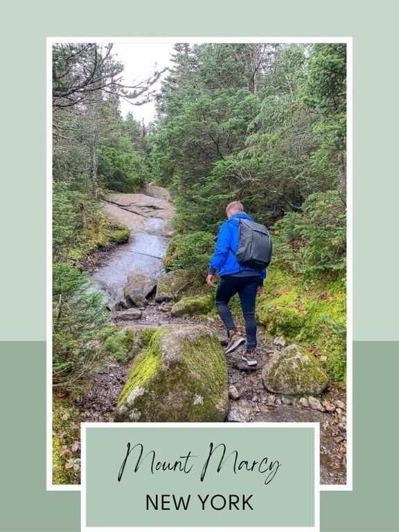 man hiking mount marcy which is one of the best hiking trails in new york state