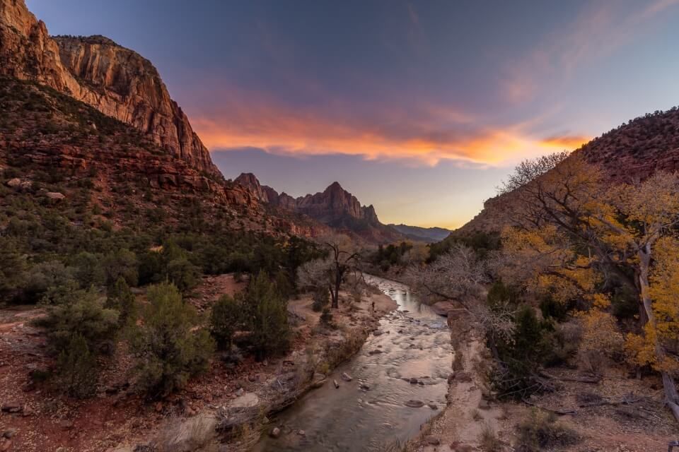 Canyon junction bridge looking back over Pa'rus trail in zion national park at dusk sunset with colors in the sky over the virgin river