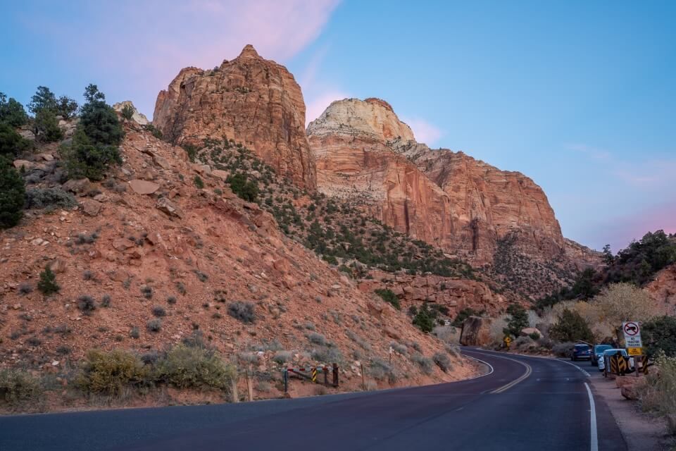 Canyon junction bridge tiny parking lot at dusk with pink clouds in utah