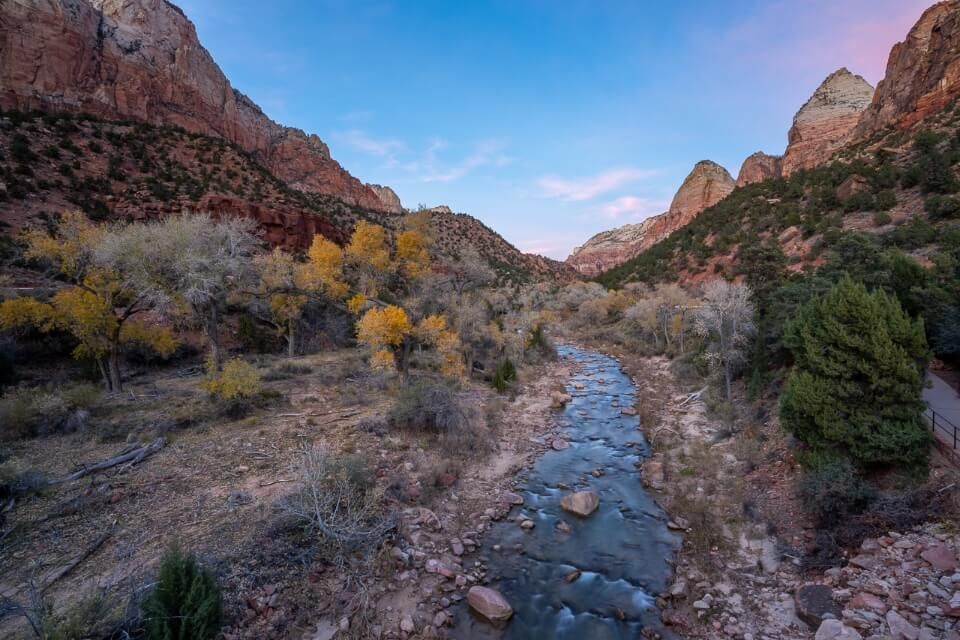 Stunning virgin river cutting through zion national park in utah surrounded by towering walls at dusk hiking the Pa'rus Trail
