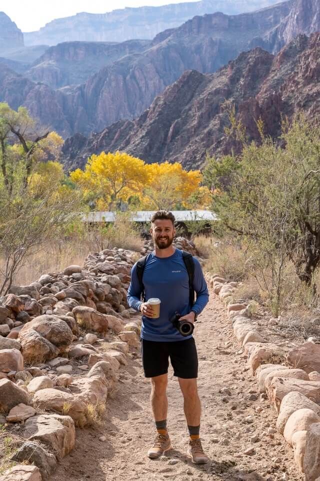 Hiker drinking hot chocolate at the bottom of grand canyon phantom ranch