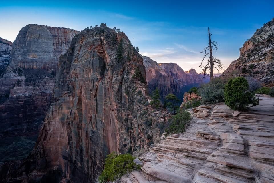 Angels Landing at sunrise incredible photo of the famous Zion hike with no hikers and a low light glow in Utah