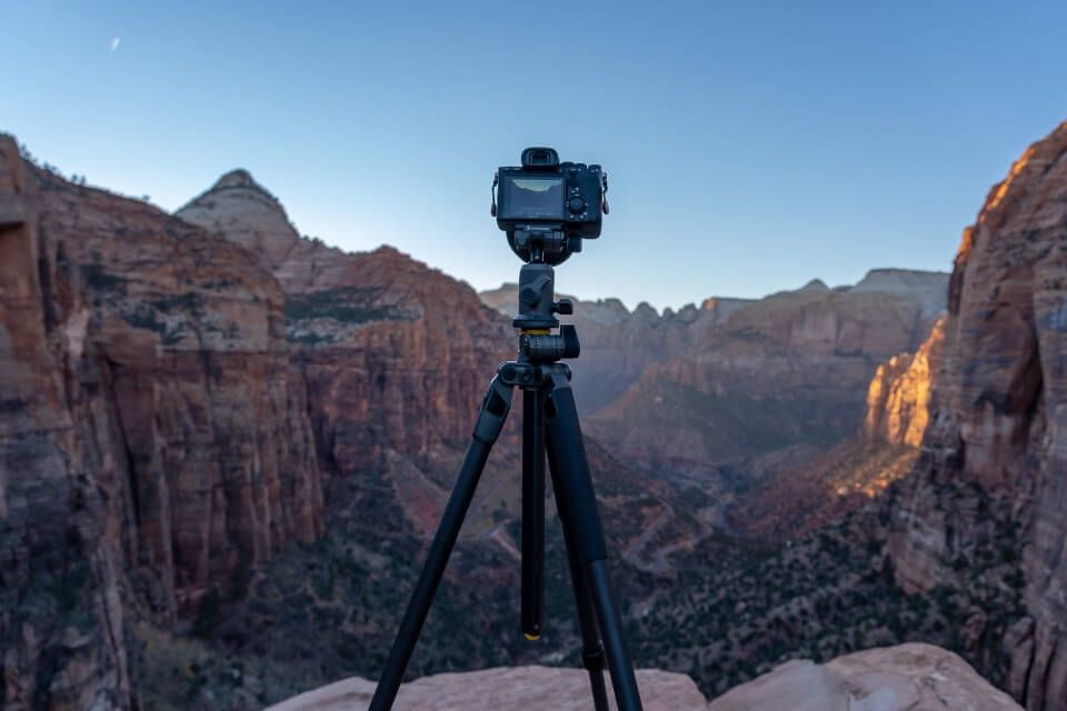 Camera on tripod taking photos of Zion Canyon Overlook at sunset in Zion National Park