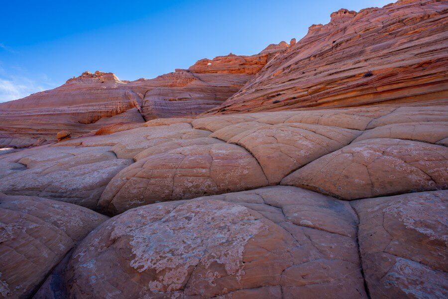 Smooth rock formations in shadow with blue sky