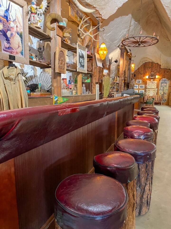 Old bar area with leather seats and paintings on wall