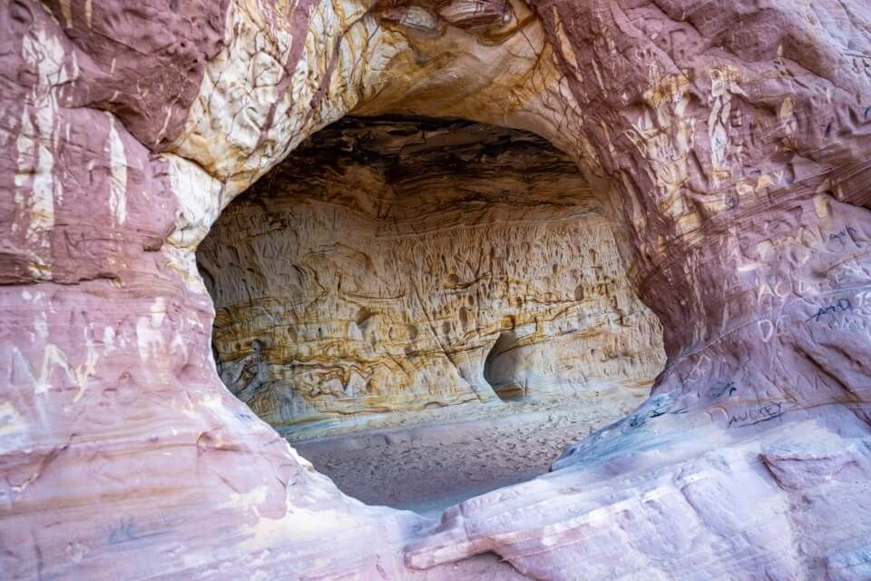 Window like arch in a rock with intricate eroded formations