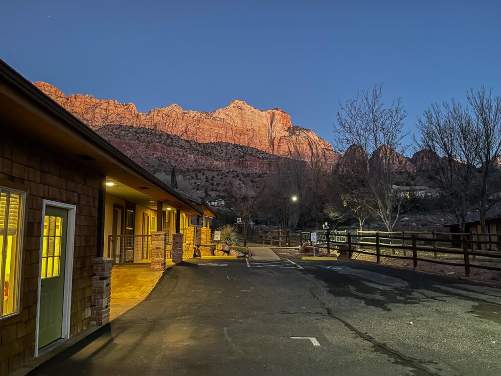 Springdale hotel before sunrise with orange canyon walls illuminating