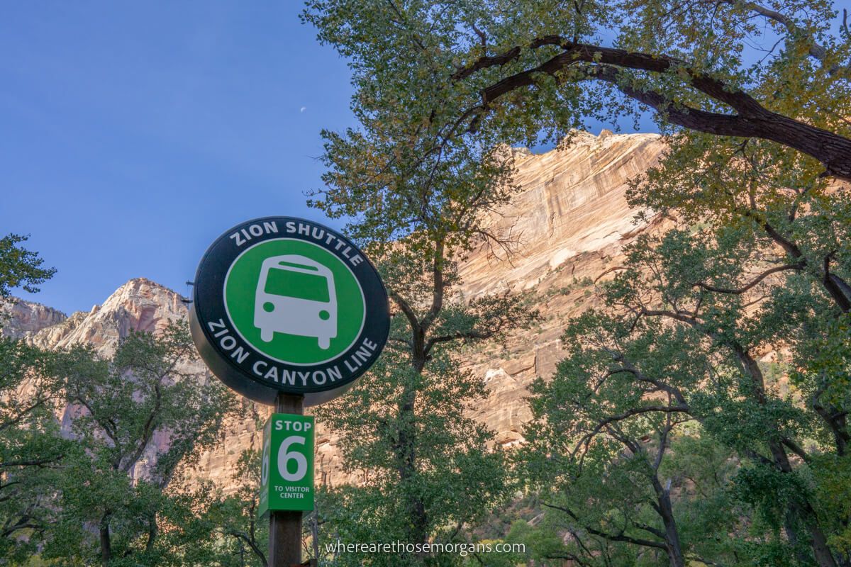 Sign marking Zion shuttle stop 6 The Grotto with tall cliff walls behind