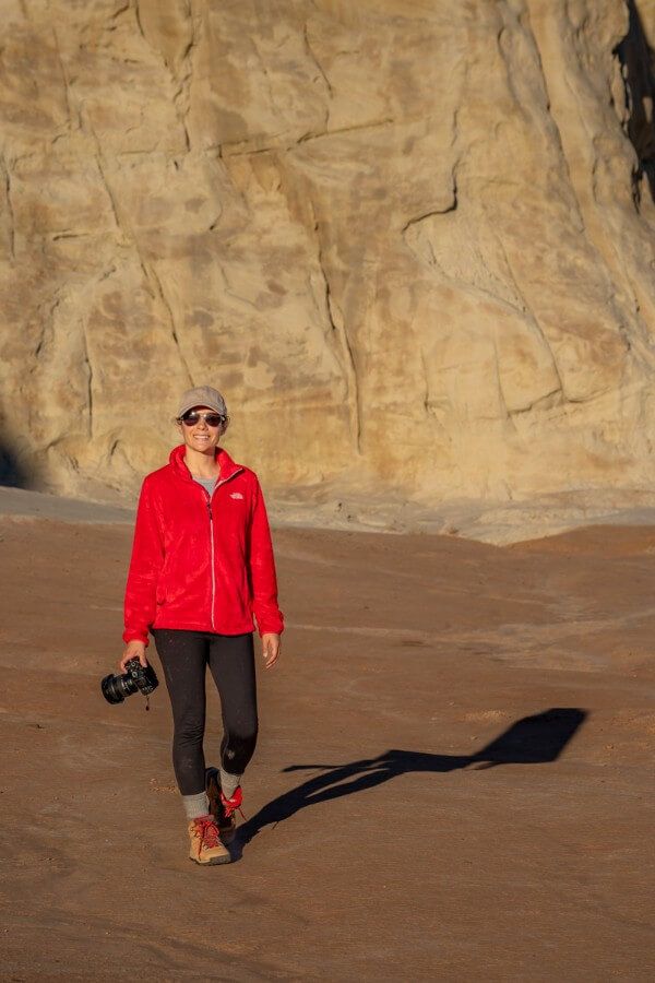 Hiker with camera at sunset in Toadstool Hoodoos hiking trail near kanab utah