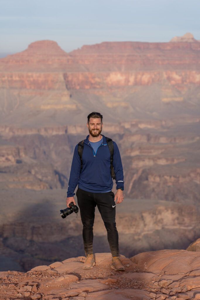 Man holding a camera at grand canyon south rim