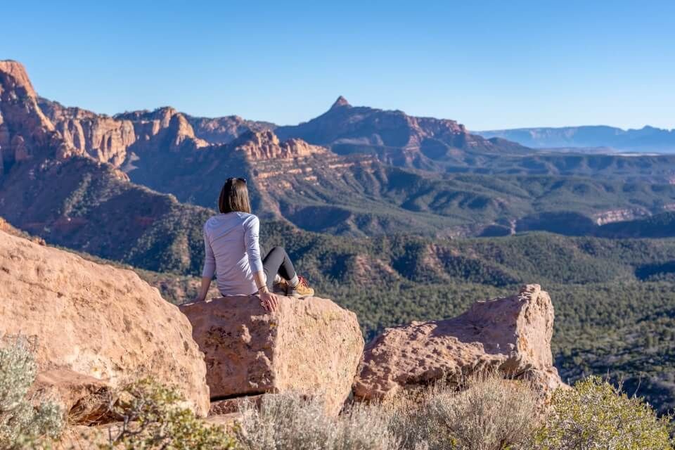 Hiker relaxing on a rock with stunning views in Utah