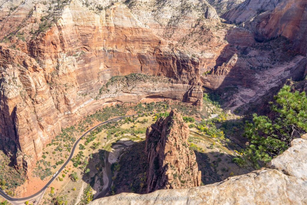 Looking down into Zion canyon from above stunning curving sandstone walls and road cutting through valley floor