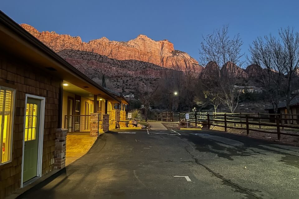 Sunrise at a hotel in Springdale Utah with orange canyon walls glowing at dawn