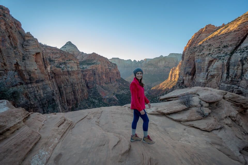 Zion Canyon Overlook at sunset hiker posing for photo stunning landscape