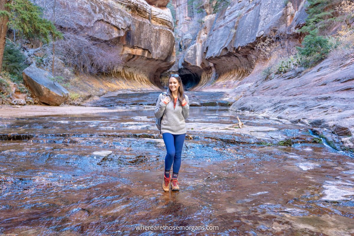 Photo of a hiker stood in front of the natural formation in Zion known as The Subway